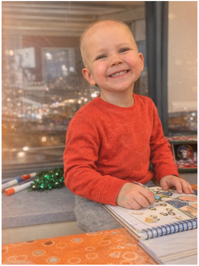 Parker smiling in a red shirt.