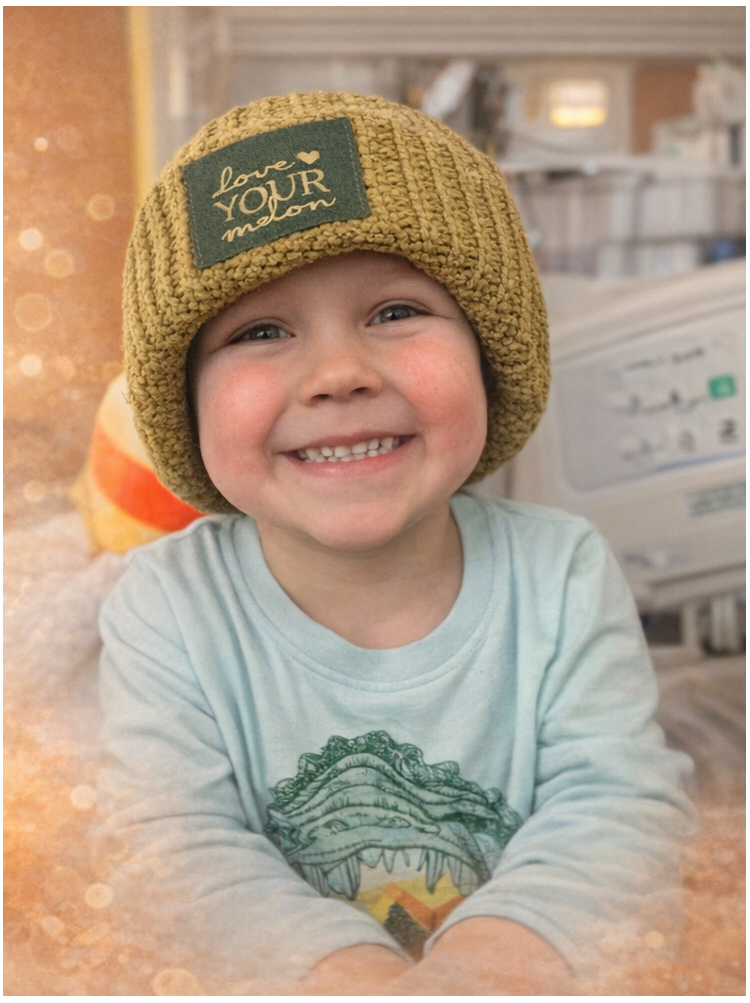 Parker in the hospital wearing a knit hat.